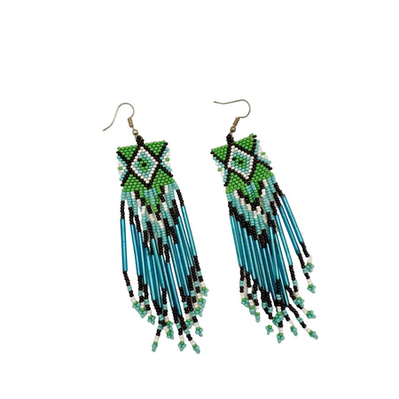 Pair of beaded earrings with blue, green, and black patterns on a beige background