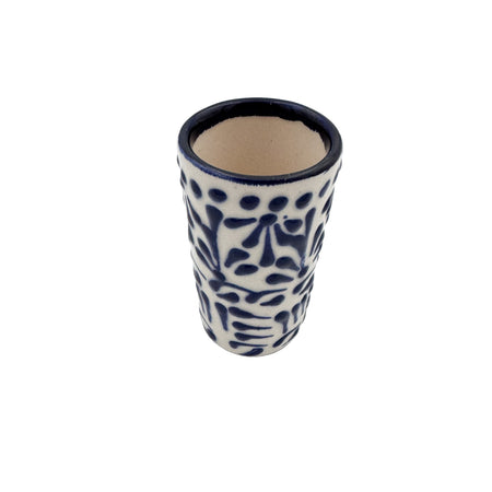 Ceramic tumbler with blue floral patterns on a white background