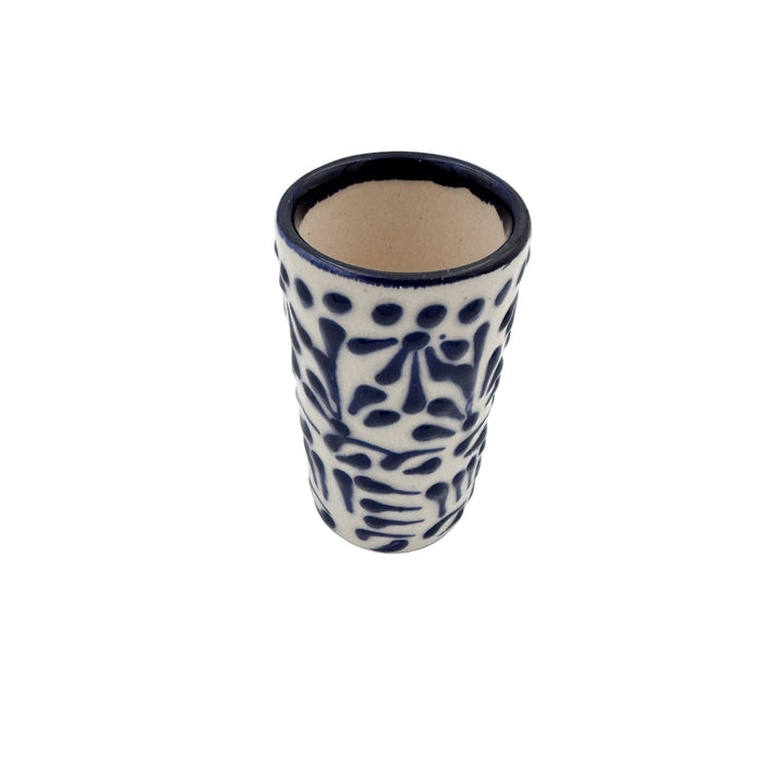 Ceramic tumbler with blue floral patterns on a white background