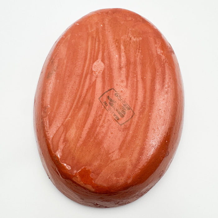 Reddish-brown stone with a visible brand logo on a white background