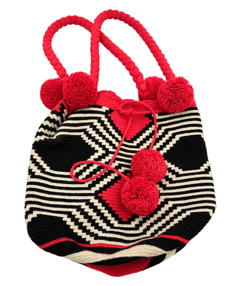 Striped bag with red pom-poms on a white background