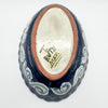 Ceramic bowl with blue patterns and a visible brand name on a white background