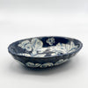 Ceramic bowl with blue and white floral patterns on a white background